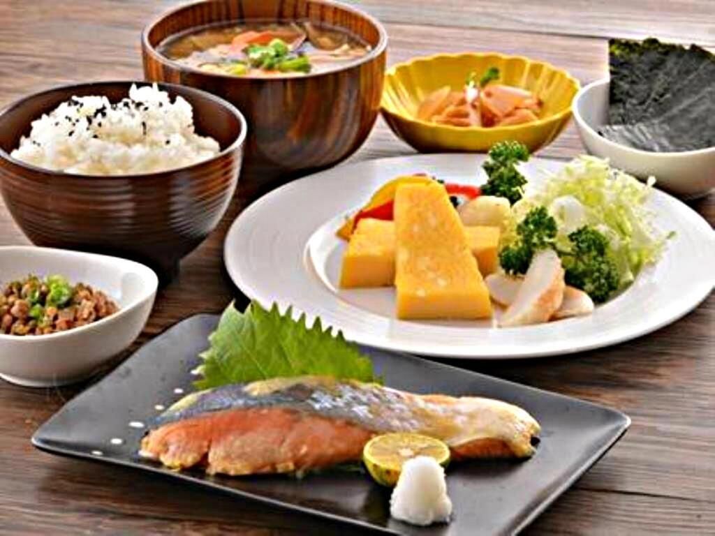A variety of dishes including fish, rice, and vegetables, suggesting a meal setting.