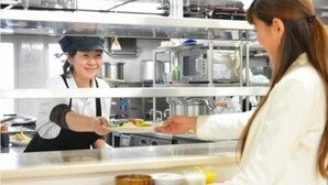 A kitchen area with stainless steel appliances and a counter where food is being prepared. - Value The Hotel Sendai Natori (Natori)
