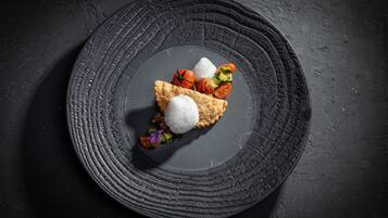A dessert on a textured plate with a dark background.