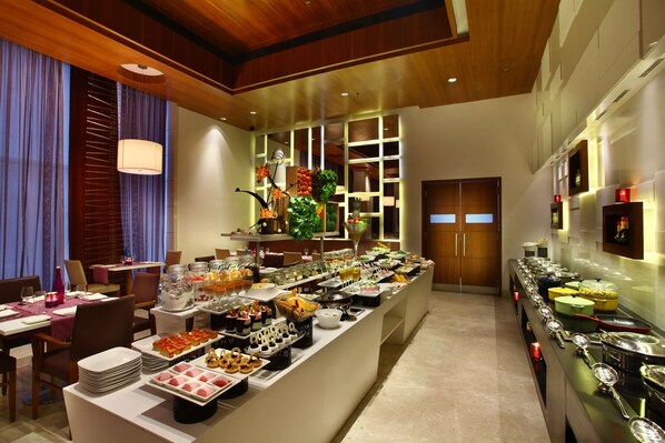 A buffet area with various food items and utensils. - Park Plaza Delhi CBD Shahdara (New Delhi)