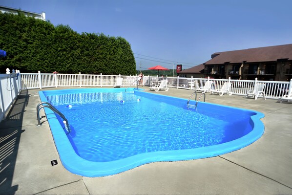 Outdoor pool, open 9 AM to 9 PM, pool umbrellas