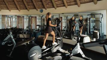 A gym with treadmills, stationary bikes, and weight machines.