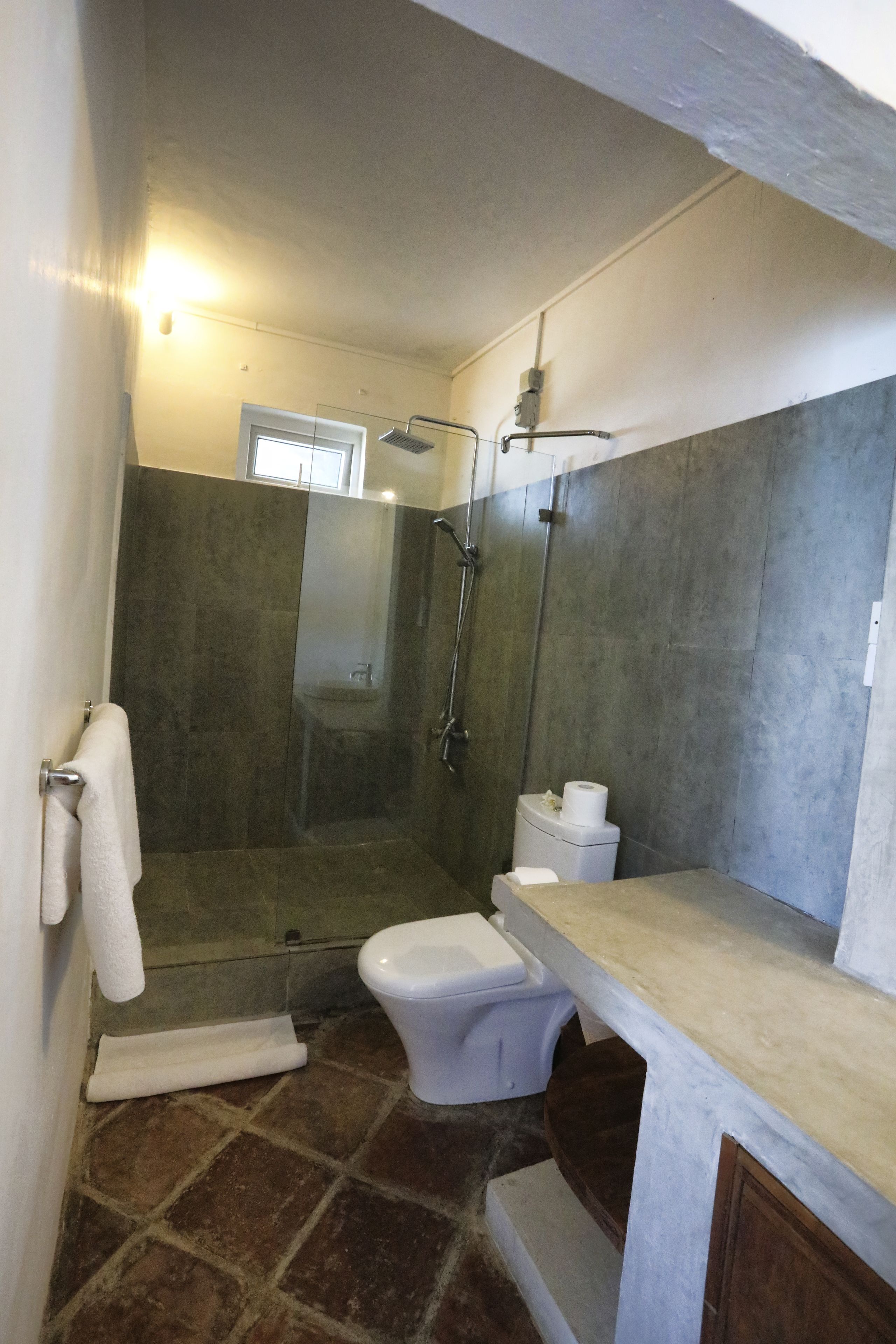 A bathroom with a shower, toilet, and sink.
