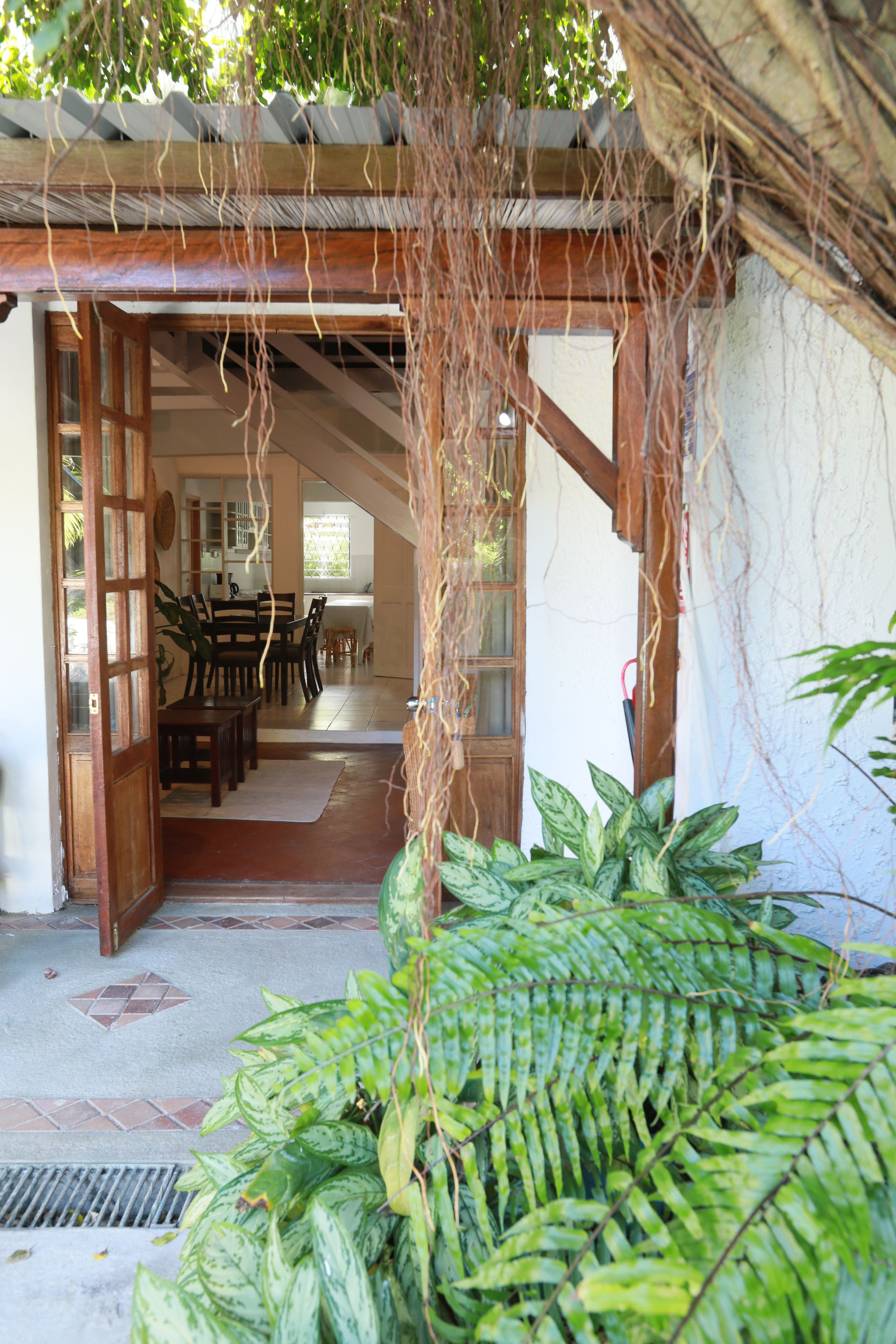 A traditional Japanese-style interior with tatami mat flooring, wooden furniture, and a shoji screen entrance.