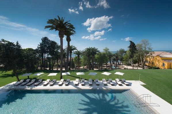 Indoor pool, outdoor pool, pool umbrellas, pool loungers