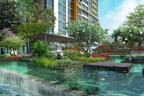 A modern hotel with a rooftop pool, lush greenery, and a waterfall feature. - Somerset Vista Ho Chi Minh City (Ho Chi Minh City)