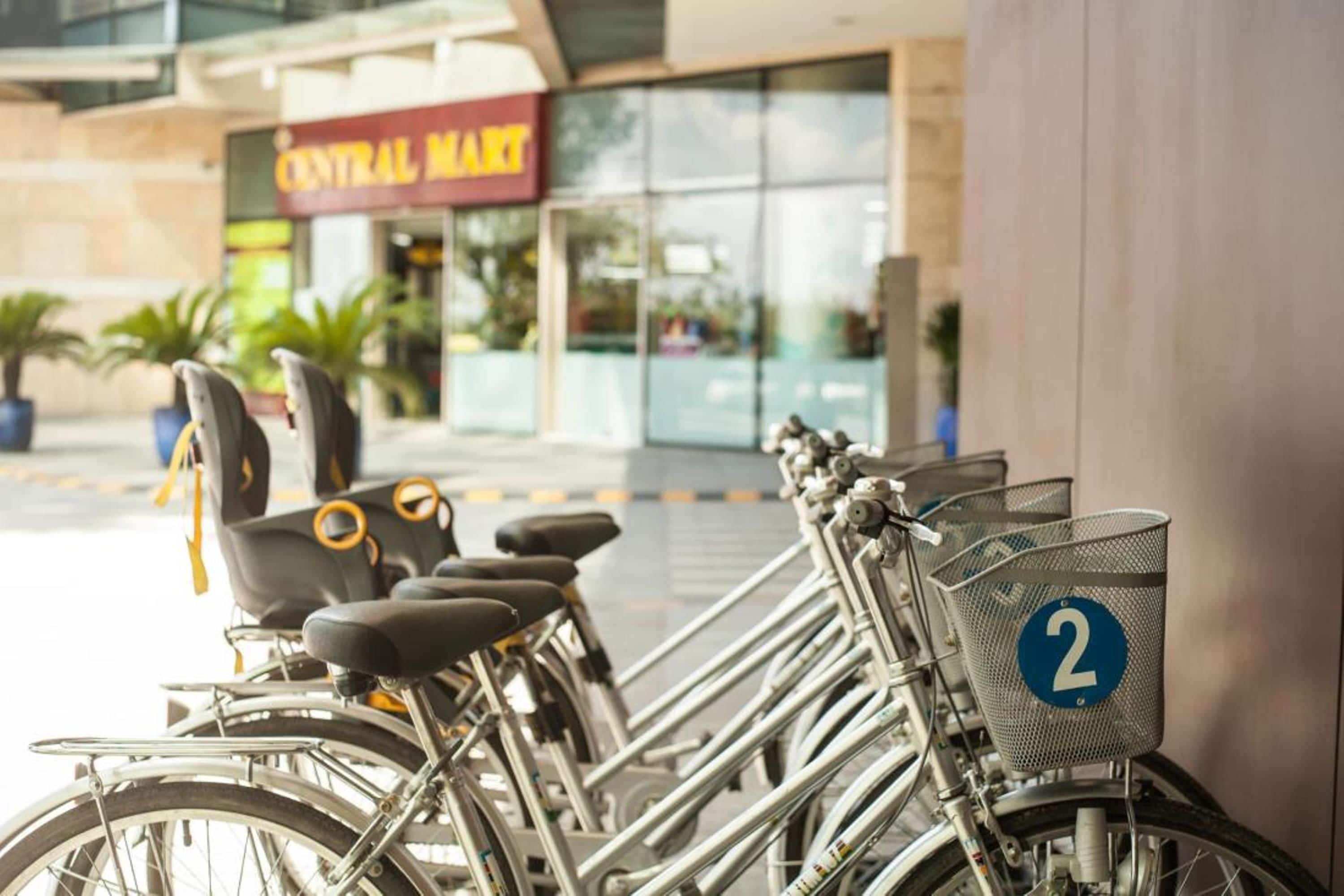A row of bicycles parked outside a building with a sign that reads "Central Mart".