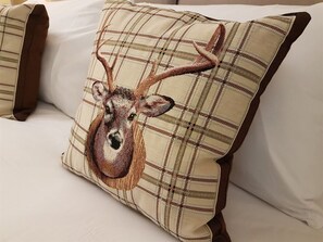 A pillow with a deer design on a bed. - The Lion Hotel (Stafford)