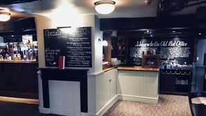 A bar area with a chalkboard menu listing specials and a welcome sign for the Old Post Office. - The Old Post Office (Shrewsbury)