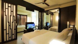 A hotel room with a large bed, a television, a desk, and a mirror. - Domaine des Alizées by Fine and Country (Grand-Baie)