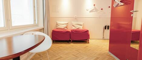 A room with a bed, a table, and a wardrobe.