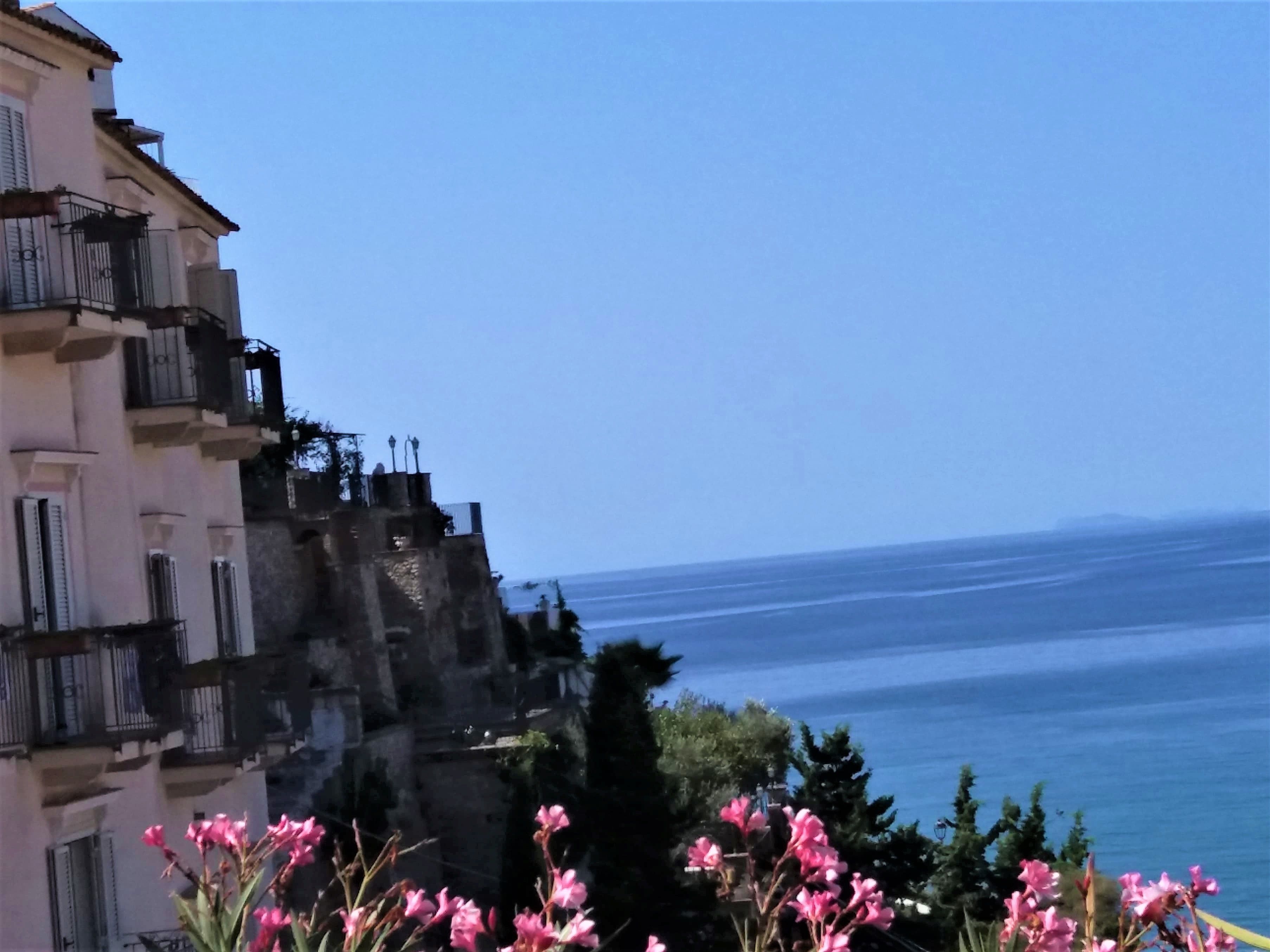 A coastal building with balconies overlooking the sea.