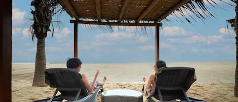 On the beach, sun-loungers, beach massages, beach volleyball