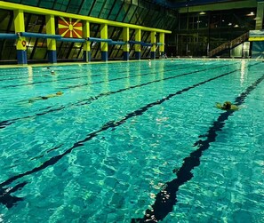 An indoor swimming pool with clear water and lane dividers. - Hotel Centar (Skopje)