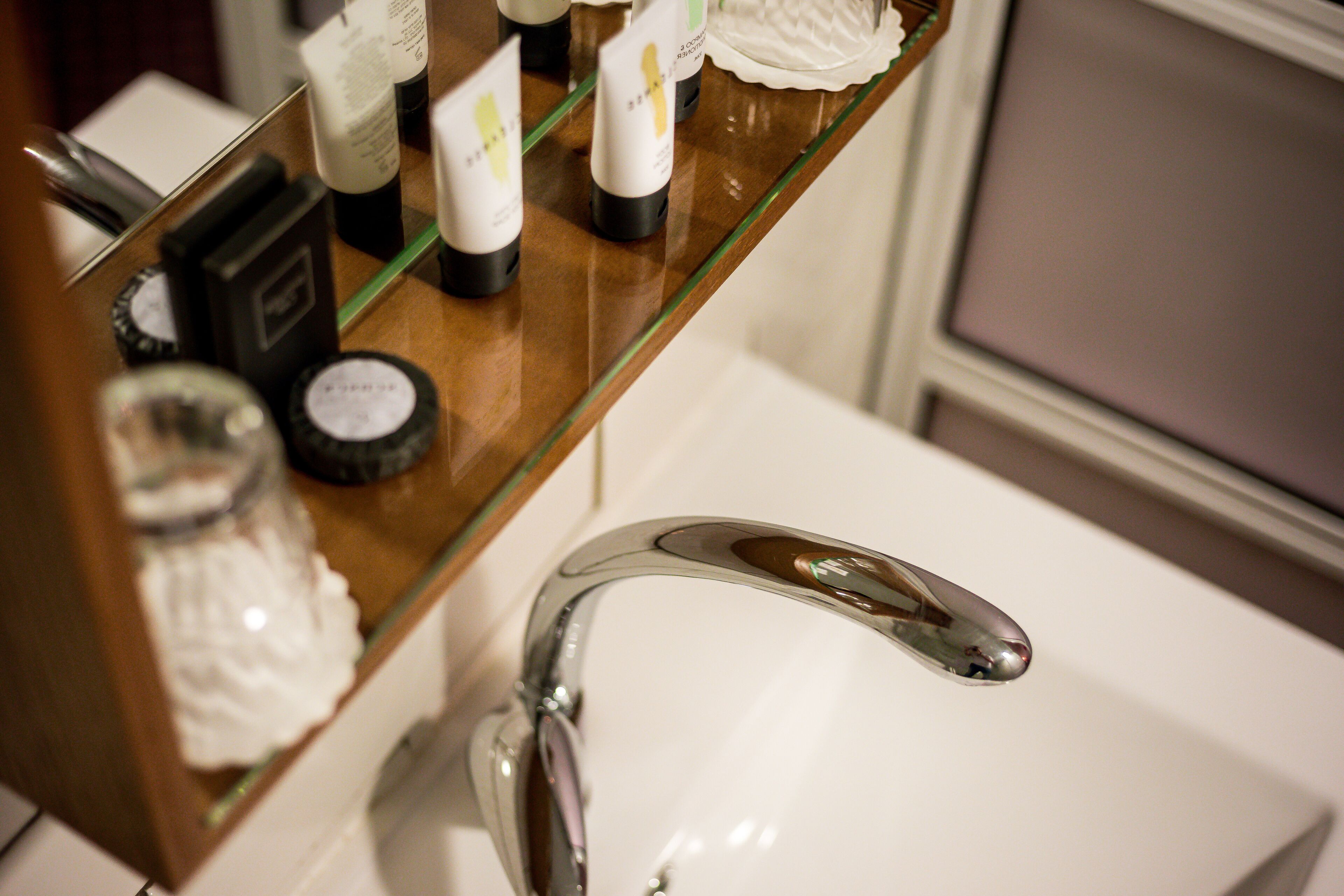 designer toiletries, hair dryer, towels