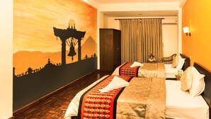 A hotel room with two beds, a mural of a temple, a curtain, and a nightstand with a lamp. - Kathmandu Eco Hotel (Kathmandu)