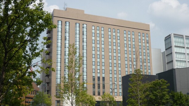 A modern building with a symmetrical facade, large windows, and a central entrance. - CYPRESS HOTEL Nagoya-eki Mae (Nagoya)