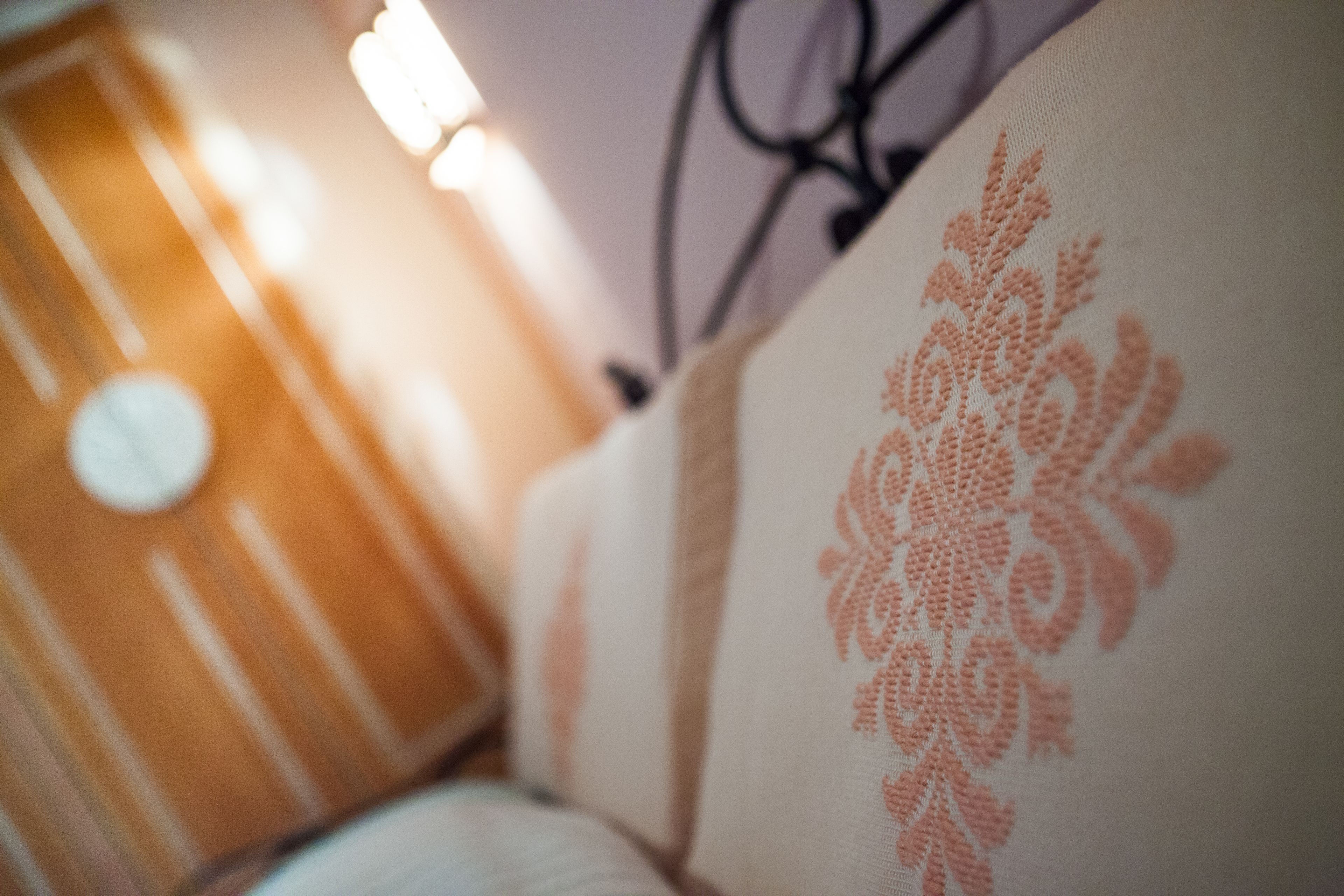 A close-up of a cushion with a floral pattern.