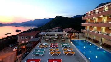 Outdoor pool, open 9:00 AM to 9:00 PM, pool umbrellas, sun loungers