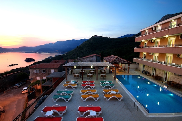 Outdoor pool, open 9:00 AM to 9:00 PM, pool umbrellas, pool loungers