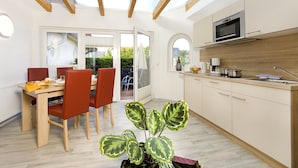 A modern kitchen with a built-in microwave, a coffee maker, and a sink. - Ferienhotel Bernstein (Trassenheide)