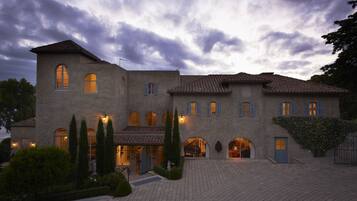Stately building with a central entrance and symmetrical facade, blending traditional and modern elements.