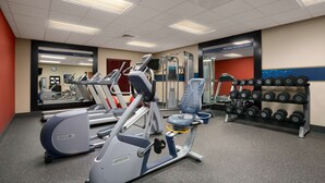 A gym with treadmills, elliptical machines, and a rack of dumbbells. - Hampton Inn Magnolia (Magnolia)