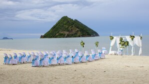 A beach wedding setup with chairs and a decorated altar. - Oriental Beach Pearl Resort (Sam Roi Yot)
