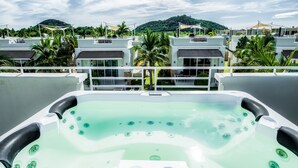 A rooftop hot tub with a clear view of a resort's buildings and a mountain in the background. - Oriental Beach Pearl Resort (Sam Roi Yot)