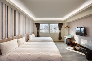 A hotel room with two beds, a TV, a desk with a lamp, and a window with curtains. - Cullinan Hotel (Hualien City)