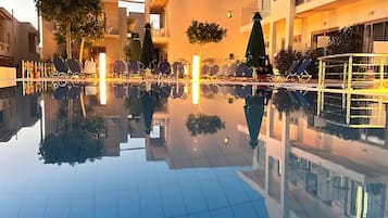 Seasonal outdoor pool, open 9:00 AM to 7:00 PM, pool umbrellas