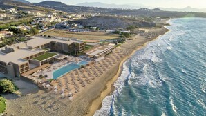 A coastal hotel with a swimming pool, beach area, and mountain views. - Unique Blue! Resort and Villas Adults Only (Hersonissos)