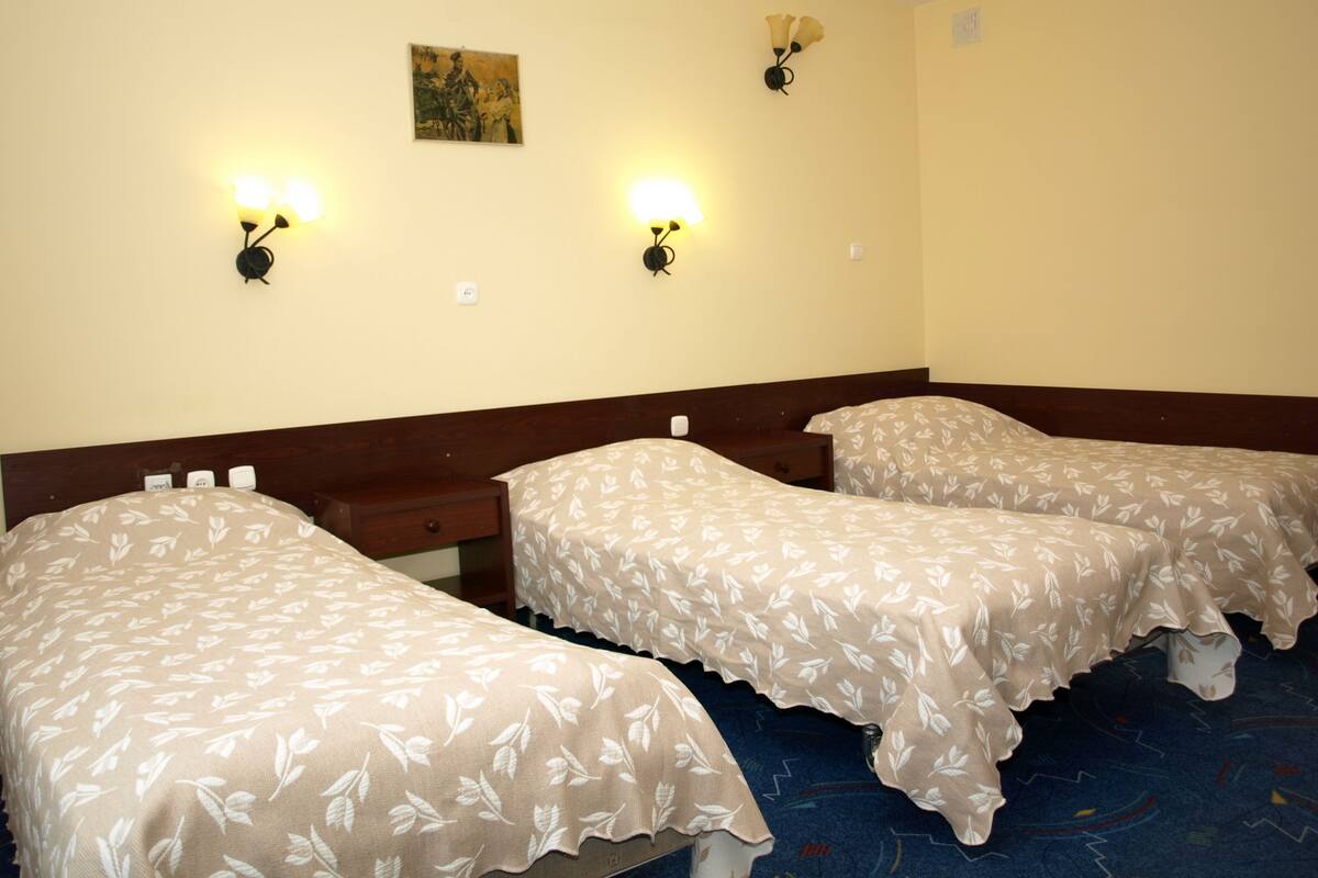 أغطية فراش متميزة وخزنة داخل الغرفة ومكتب وستائر تعتيم