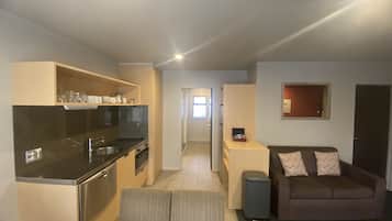 Apartment, 3 Bedrooms, Bathtub | Living area | 45-inch flat-screen TV with satellite channels, TV