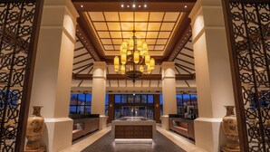 A spacious lobby with a central seating area, a chandelier, and decorative vases. - Fusaki Beach Resort Hotel & Villas (Ishigaki)