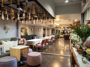A restaurant interior with tables, chairs, hanging decorations, and a counter with flowers. - sala lanna Chiang Mai (Chiang Mai)