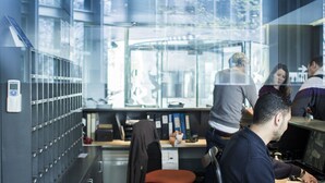 A modern office with cubicles, a filing cabinet, and a glass wall. - Centre Esplai Hostel (El Prat de Llobregat)