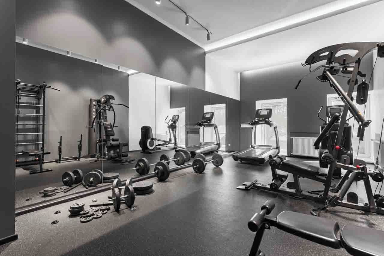 A gym with weightlifting equipment, treadmills, and exercise machines.