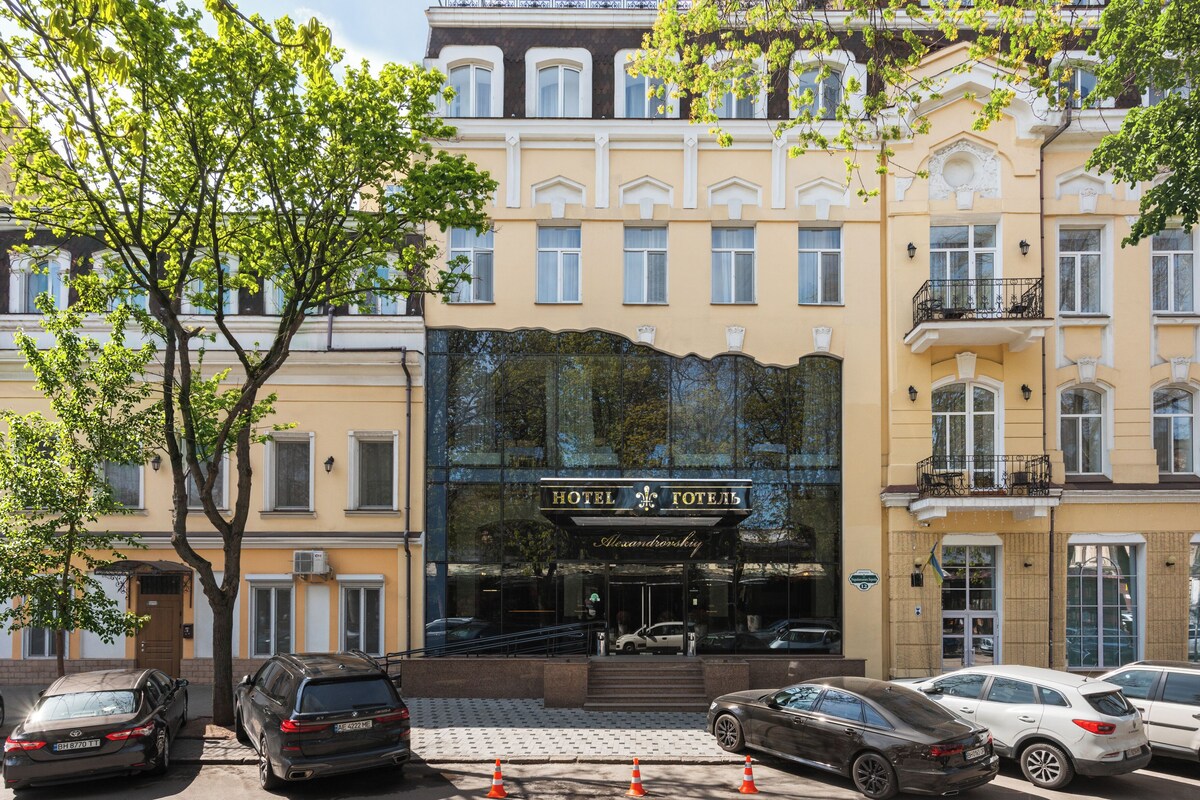 A hotel with a classic facade, large windows, and a prominent entrance.