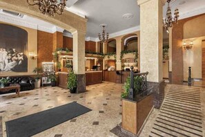 A spacious lobby with a marble floor, a reception desk, and a staircase. - Aleksandrovskiy Hotel (Odesa)