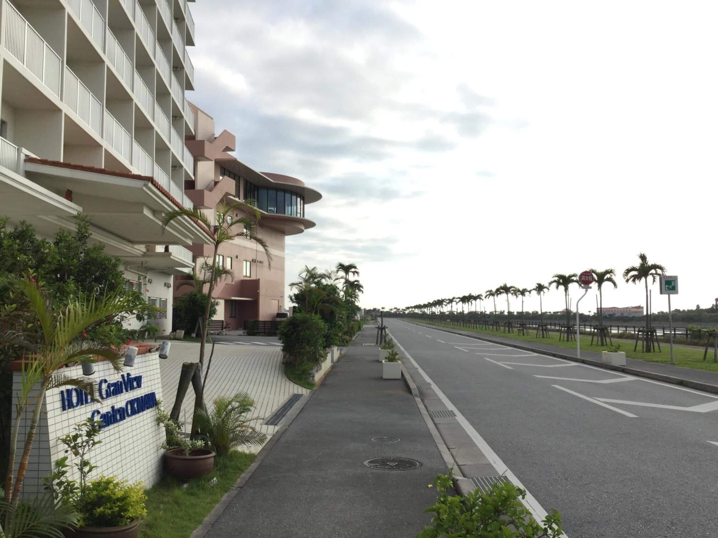 A hotel with a modern design, featuring a prominent entrance and a sign for the Grand View Center.