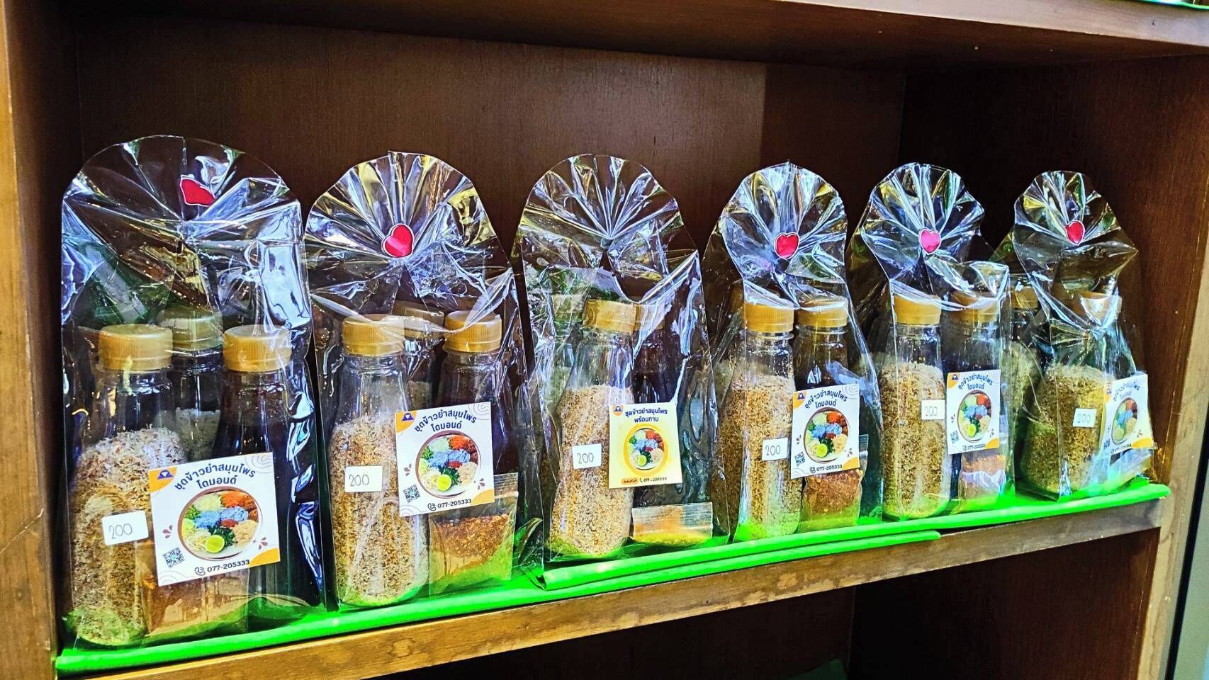 A shelf with glass jars containing various food items, each labeled with a price tag.