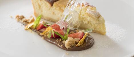 A dessert plate with a piece of cake and chocolate sauce.