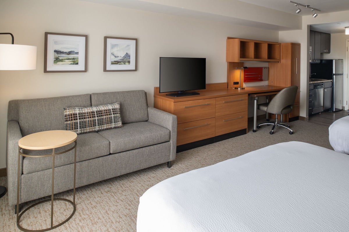 Premium bedding, desk, laptop workspace, blackout drapes