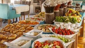 A buffet with various dishes including salads, fruits, and meats. - Ottoman Cave Suites (Nevsehir)