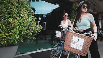 A bicycle with a basket labeled "My Place Hotel".