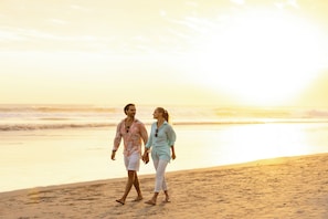 A couple walking on a beach during sunset. - Amadea Resort & Villas (Seminyak)