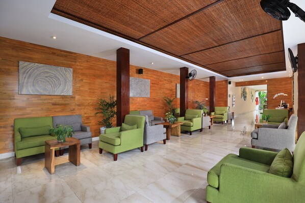 A lobby with green and grey sofas, wooden tables, and a wooden ceiling. - Amadea Resort & Villas (Seminyak)