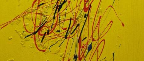A yellow wall with abstract red and black lines.
