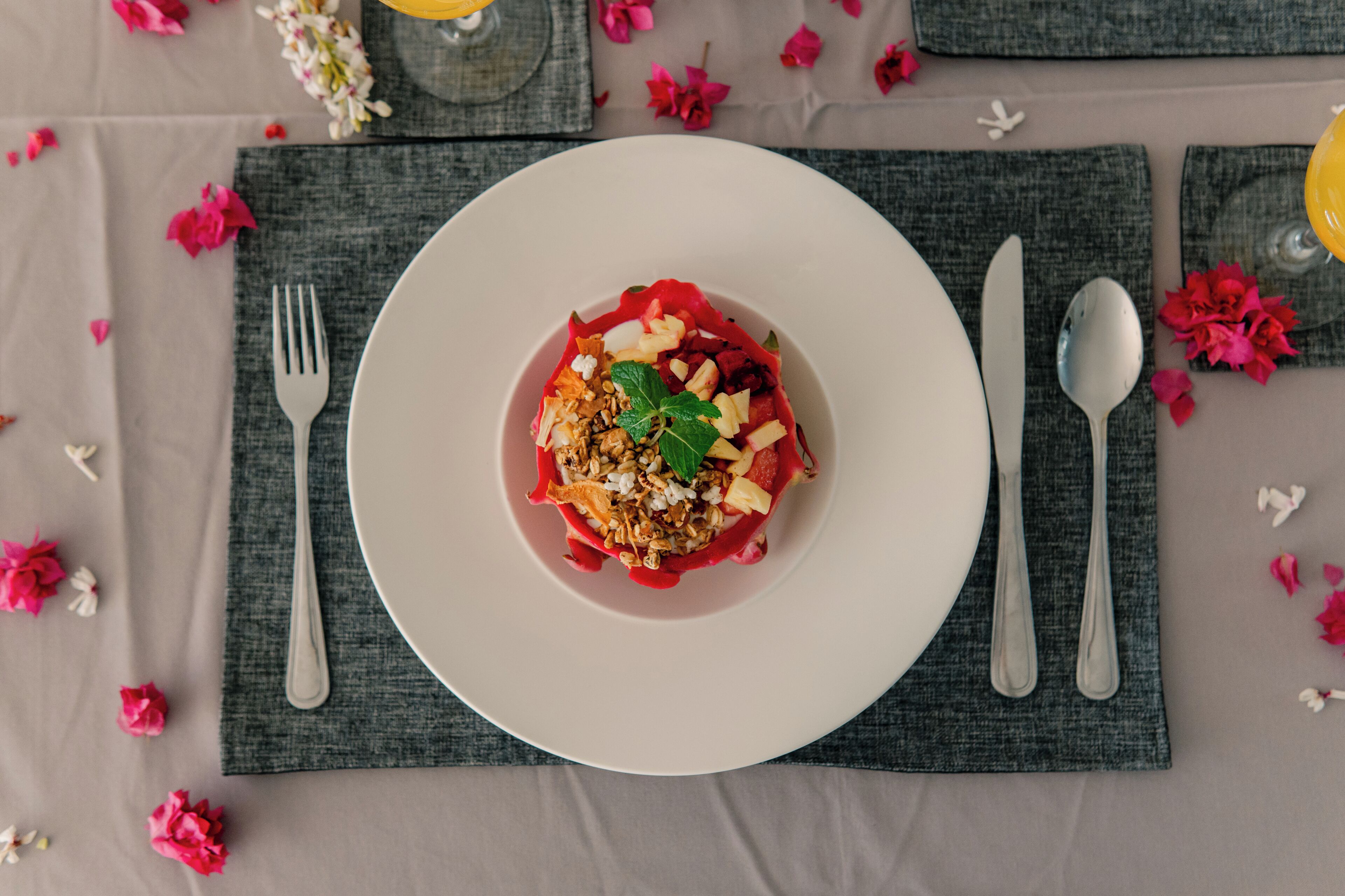 A table setting with a plate of food, cutlery, and a napkin.